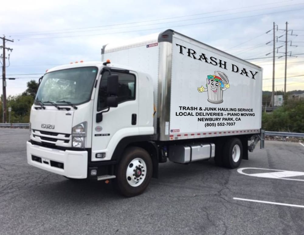The BEST MOVE TRASH DAY truck, lettered TRASH & JUNK HAULING SERVICE — LOCAL DELIVERIES — PIANO MOVING